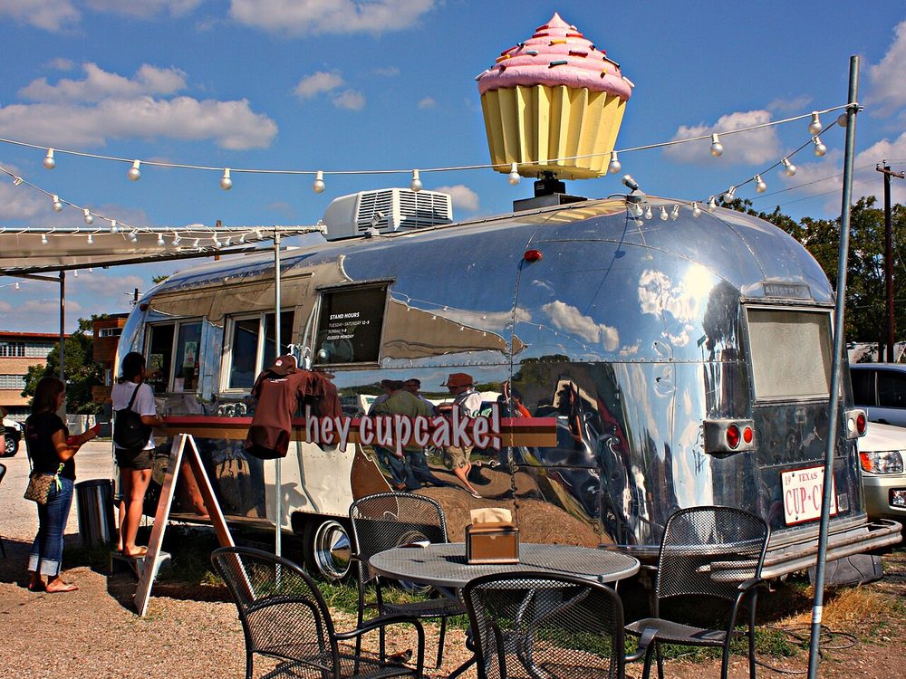 An Austin food trailer with string lights and outdoor seating